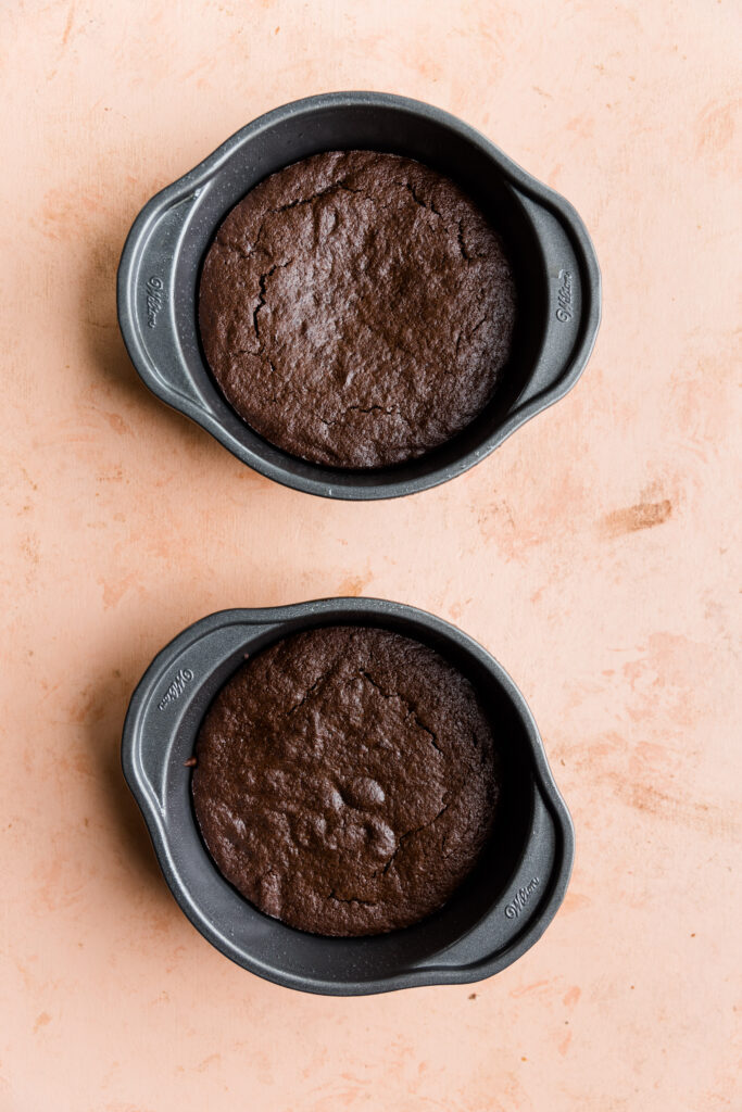 Chocolate cakes cooling in two mini cake pans.