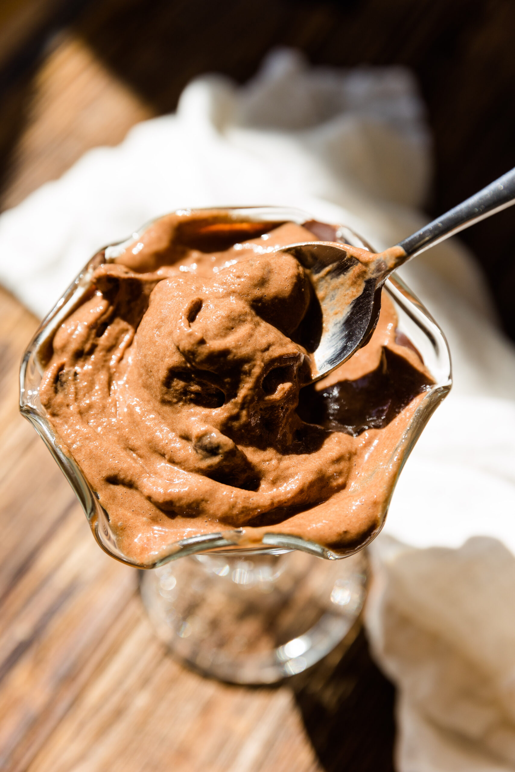 Spoon scooping out creamy chocolate nice cream.