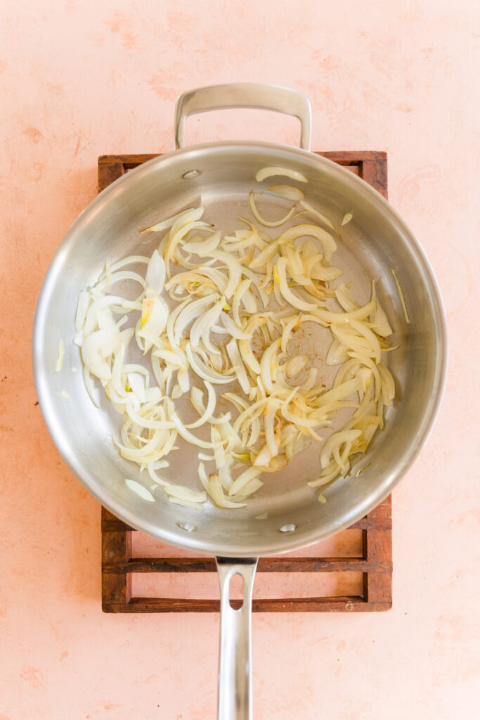 Onions sautéing in large skillet.