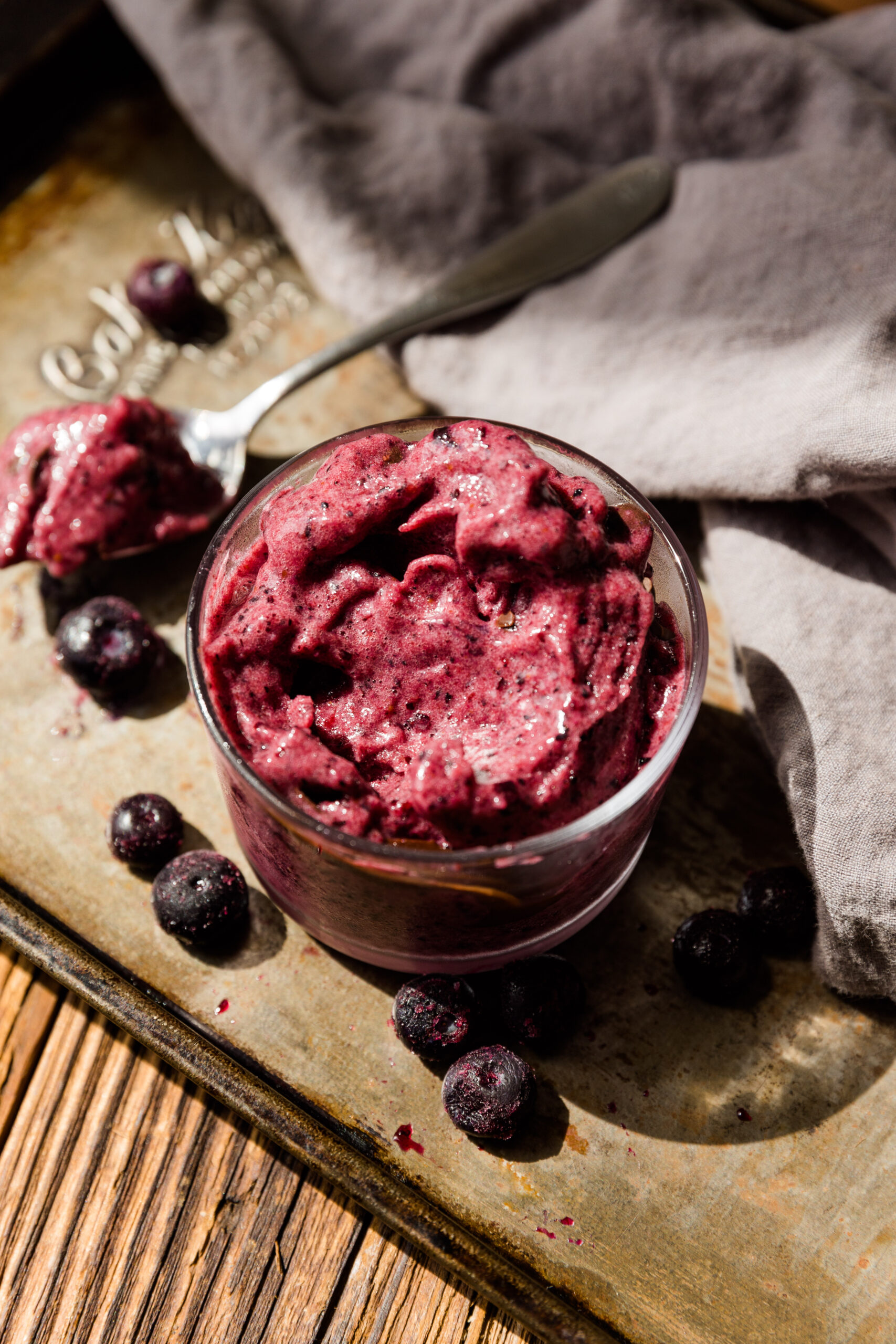 Blueberry nice cream in a small glass bowl.