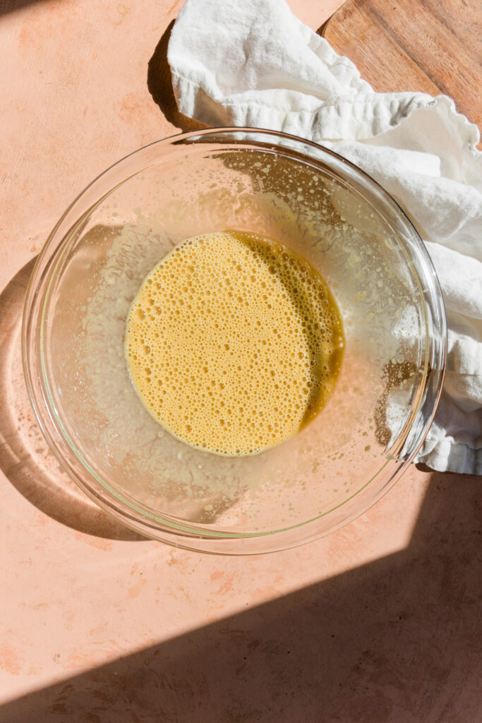 Wet ingredients in glass mixing bowl.