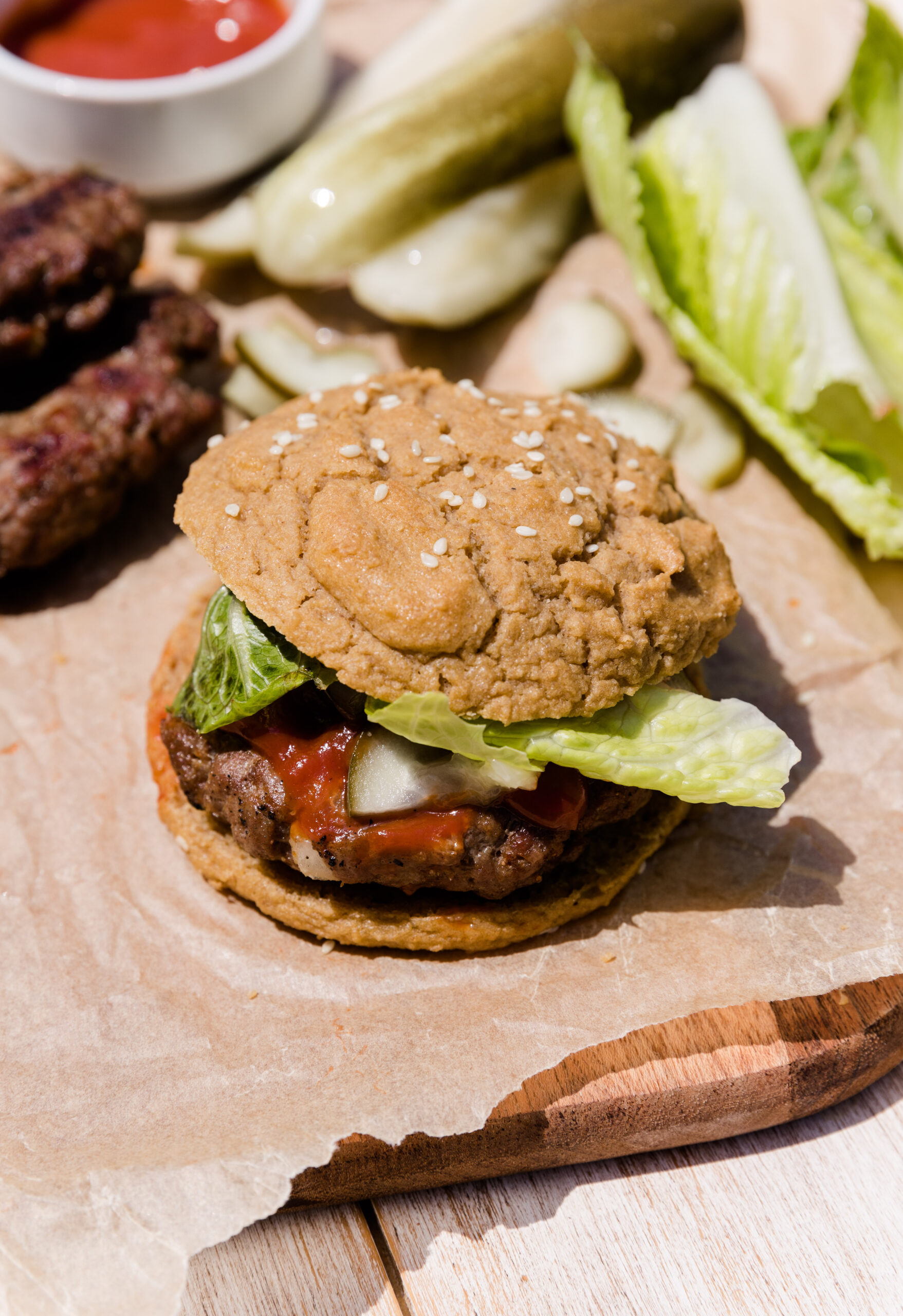 Hamburger with paleo bun, lettuce and ketchup.