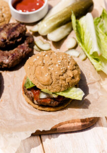 Hamburger with paleo bun, lettuce and ketchup.