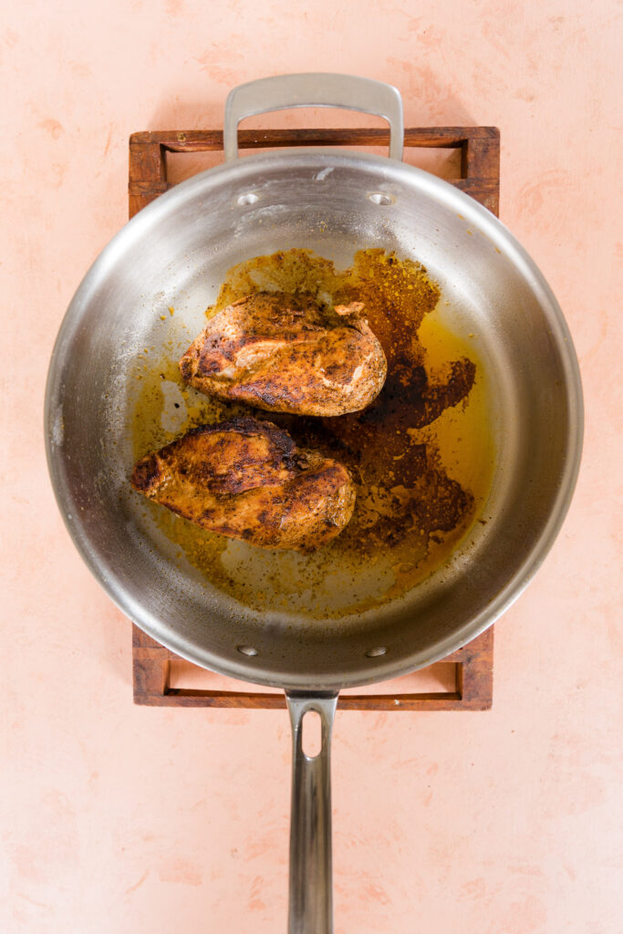 Fajita style chicken in a large pan.