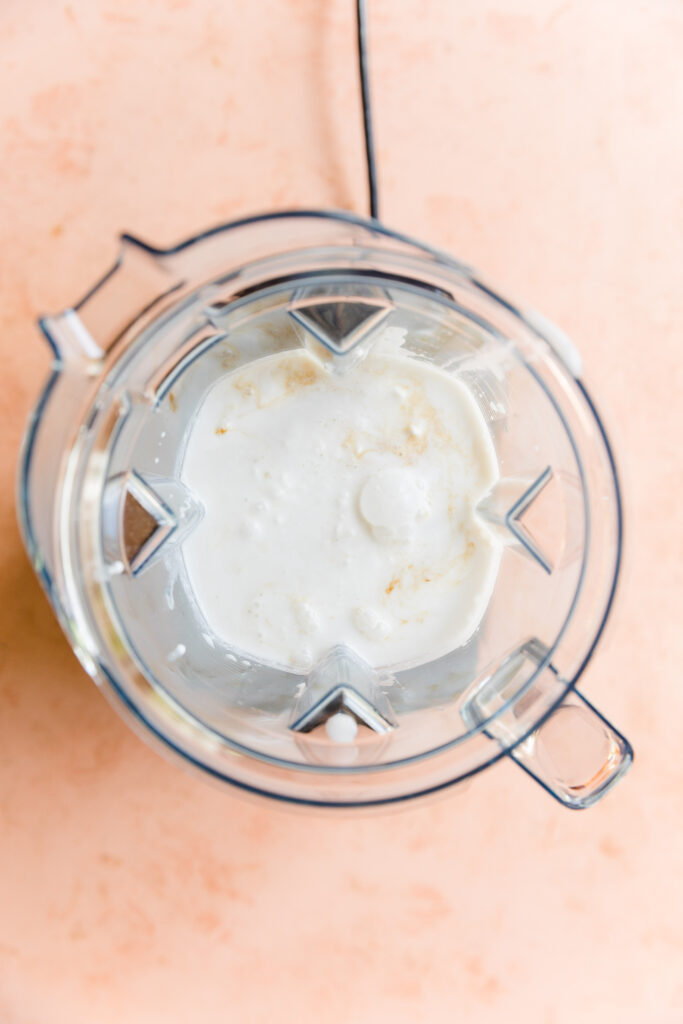 Ingredients for creamy coconut ice cream in blender.