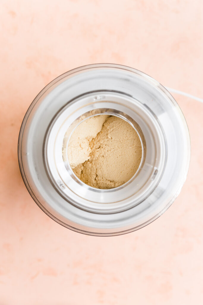 Creamy lemon ice cream in ice cream maker.