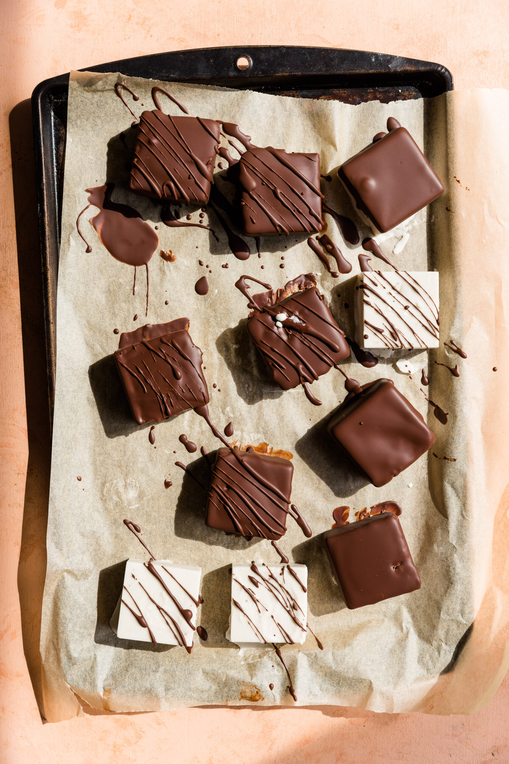 Frozen dairy free ice cream squares dipped in chocolate and drizzled with chocolate.