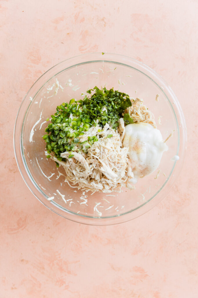 Enchilada filling ingredients in large glass mixing bowl.