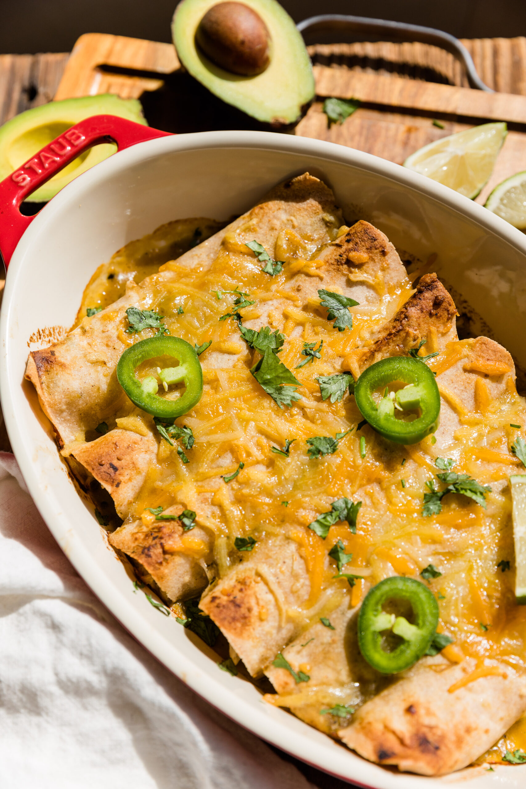 Chicken enchiladas with dairy free melted cheese and jalapeno slices on top.