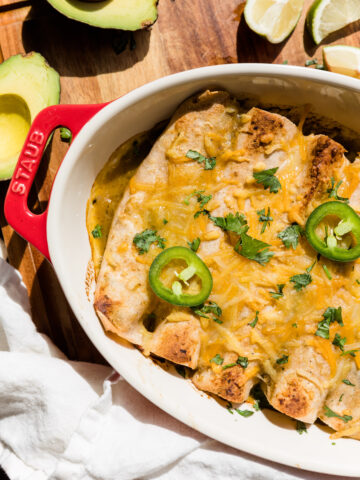 Overhead picture of chicken enchiladas in casserole dish.