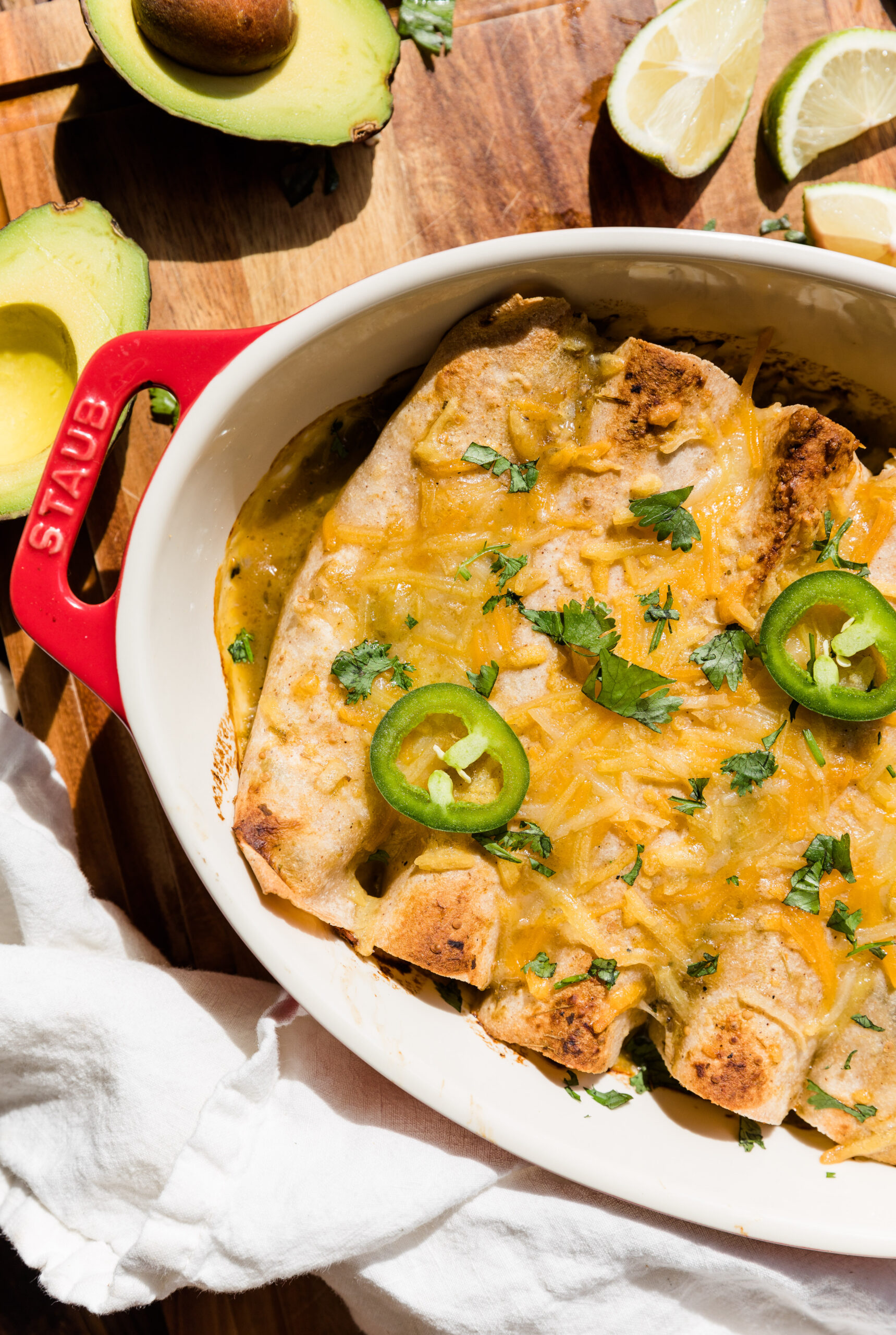 Overhead picture of chicken enchiladas in casserole dish.