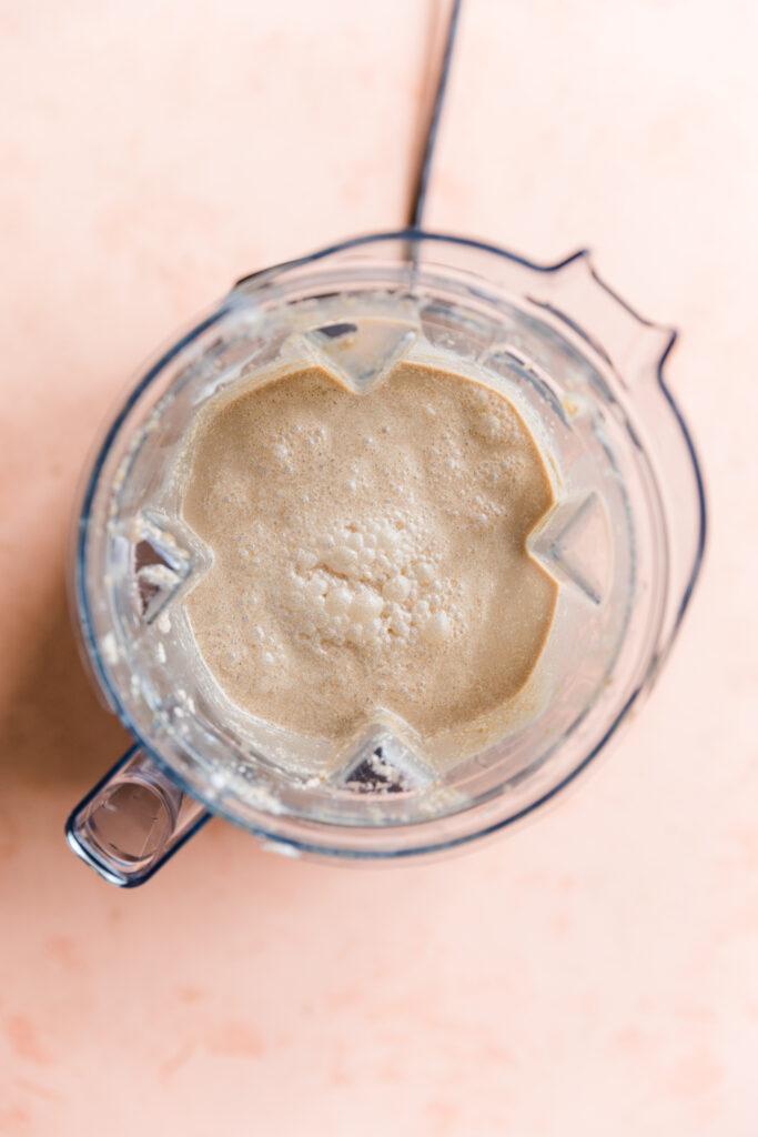 Creamy coffee ice cream mixture in blender.