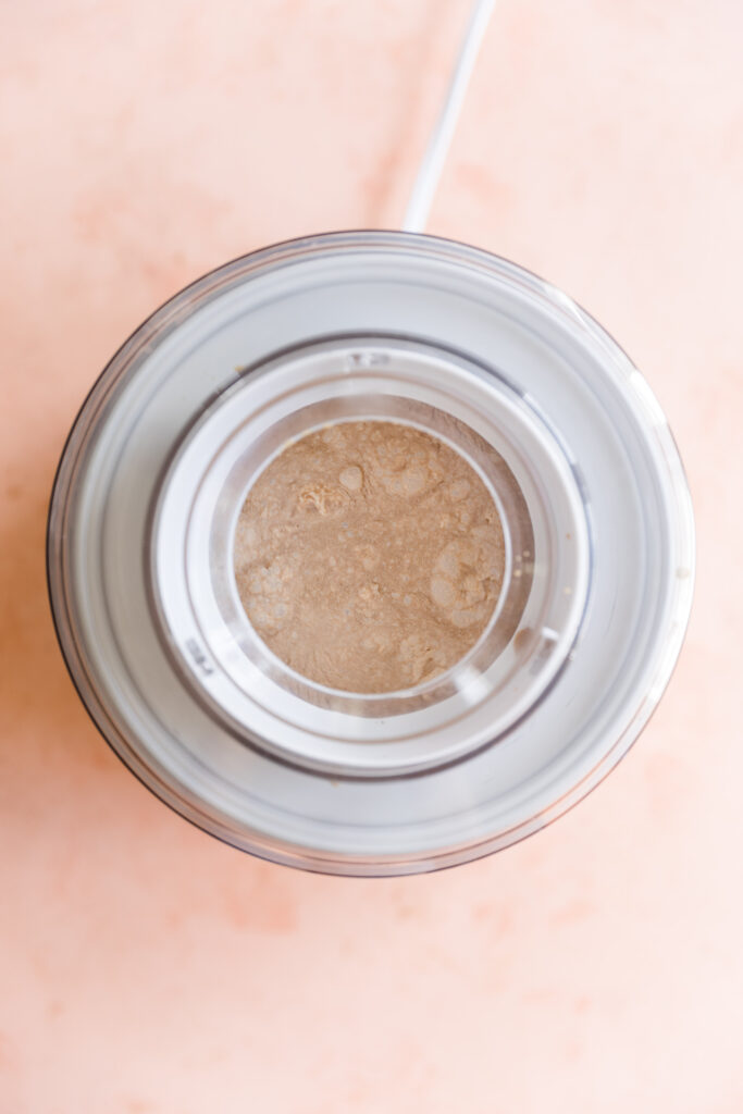 Creamy coffee ice cream in ice cream maker.