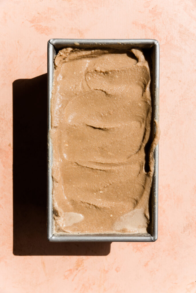 Creamy coffee ice cream in small loaf pan.