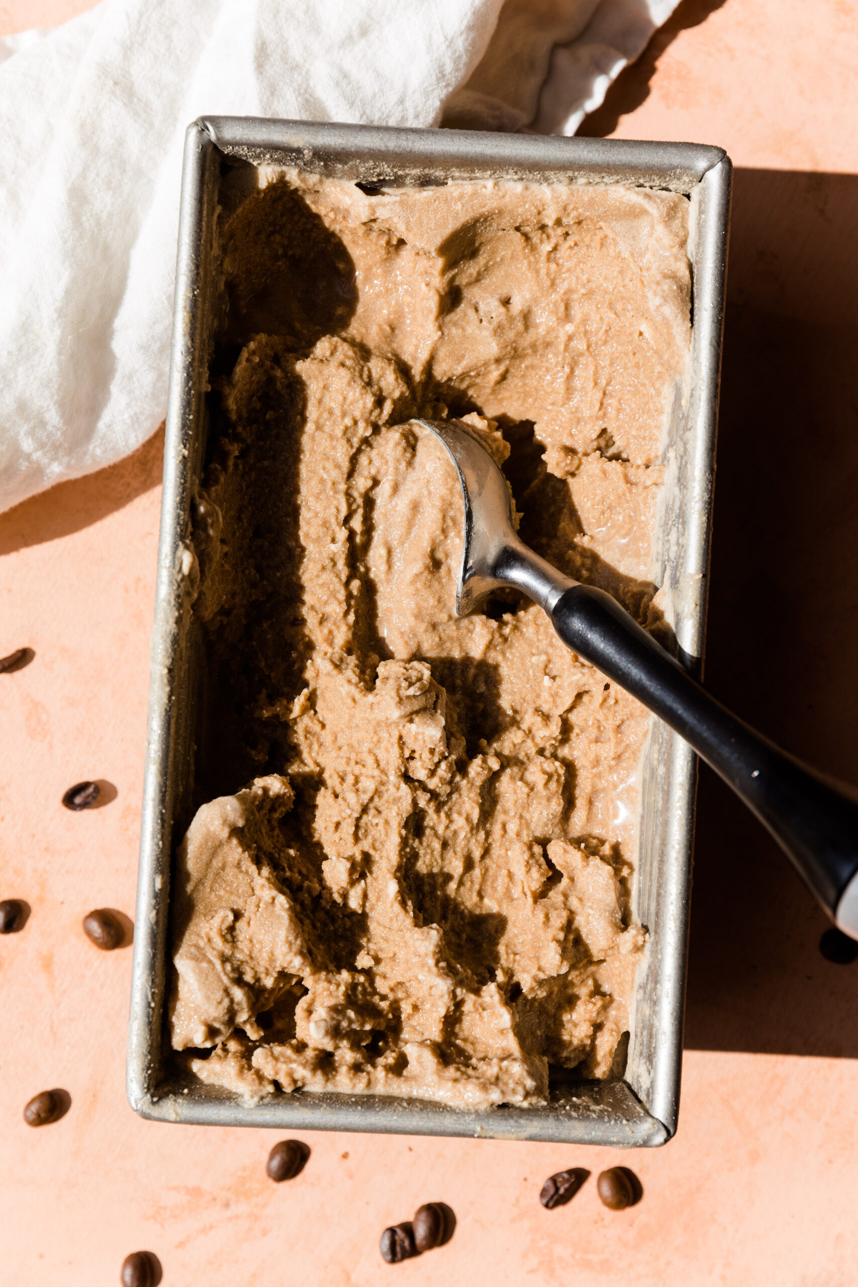 Creamy coffee ice cream melting with ice cream scoop.
