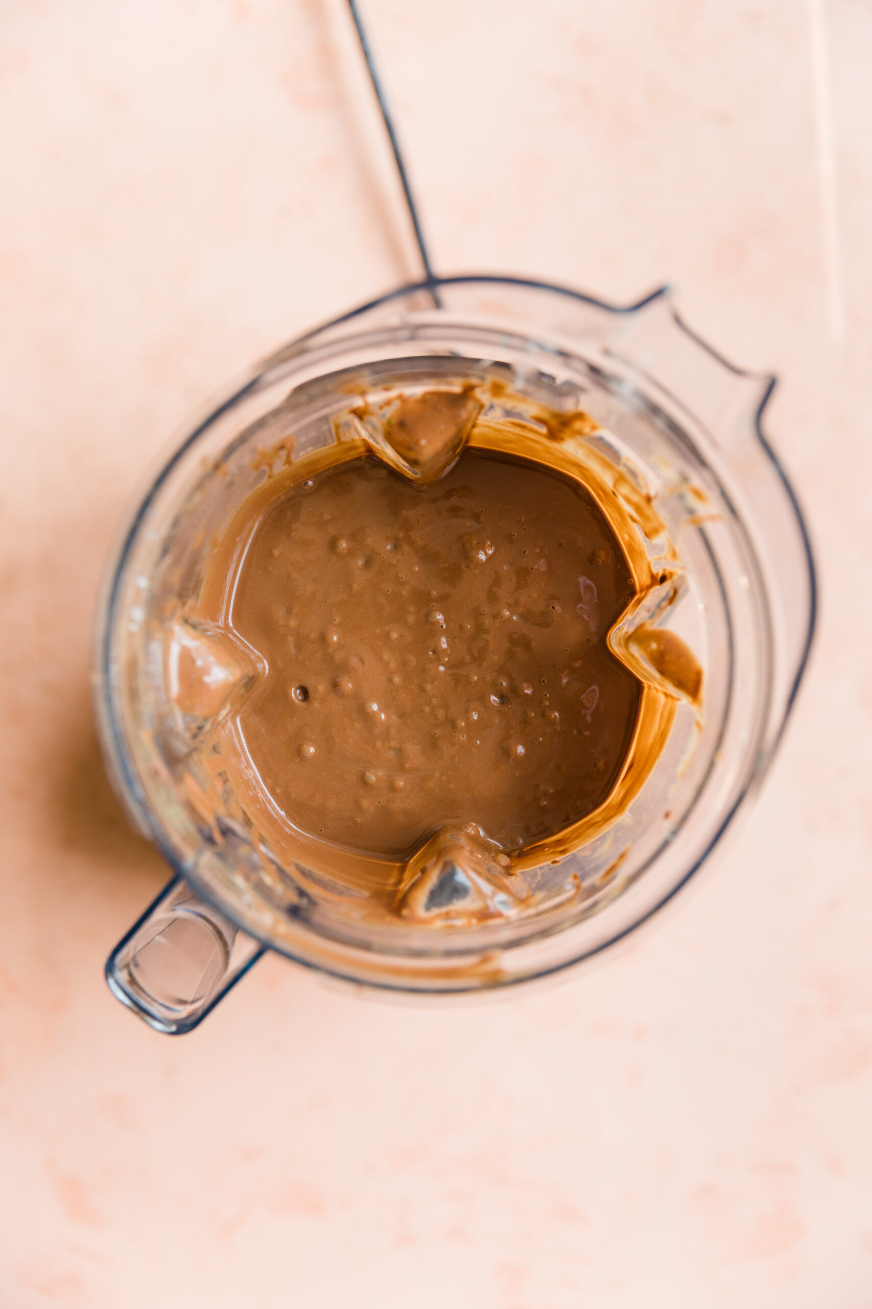 Creamy chocolate ice cream mixture in blender.