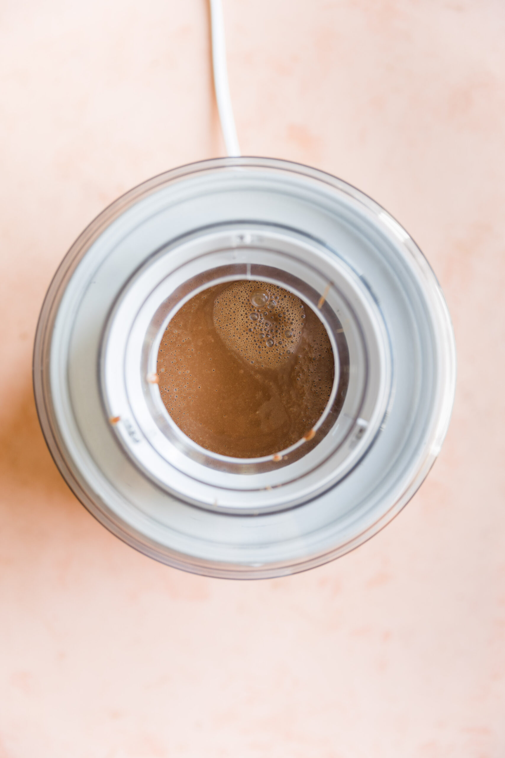 Chocolate ice cream mixture spinning in ice cream maker.