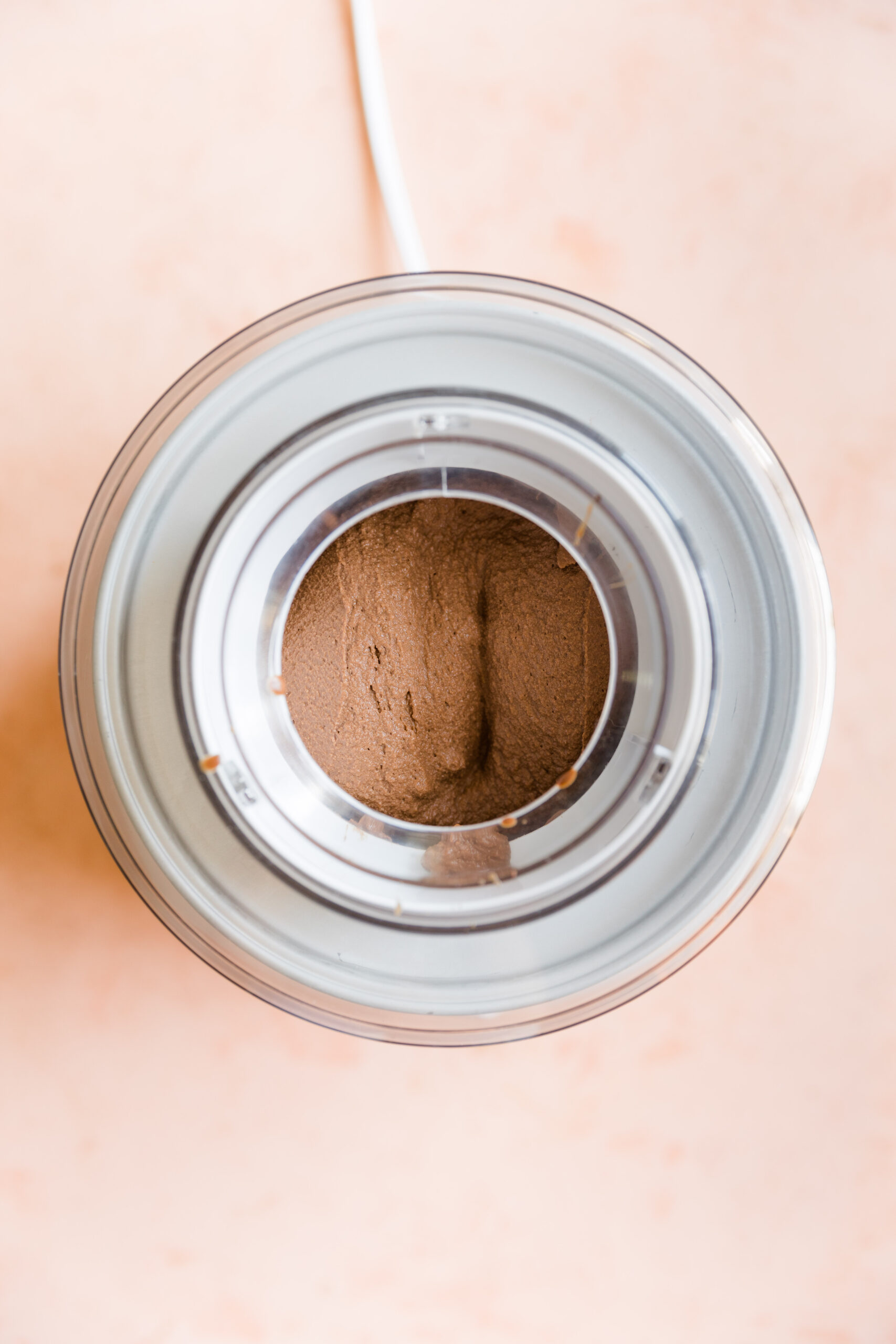 Thick and creamy chocolate ice cream in ice cream maker.