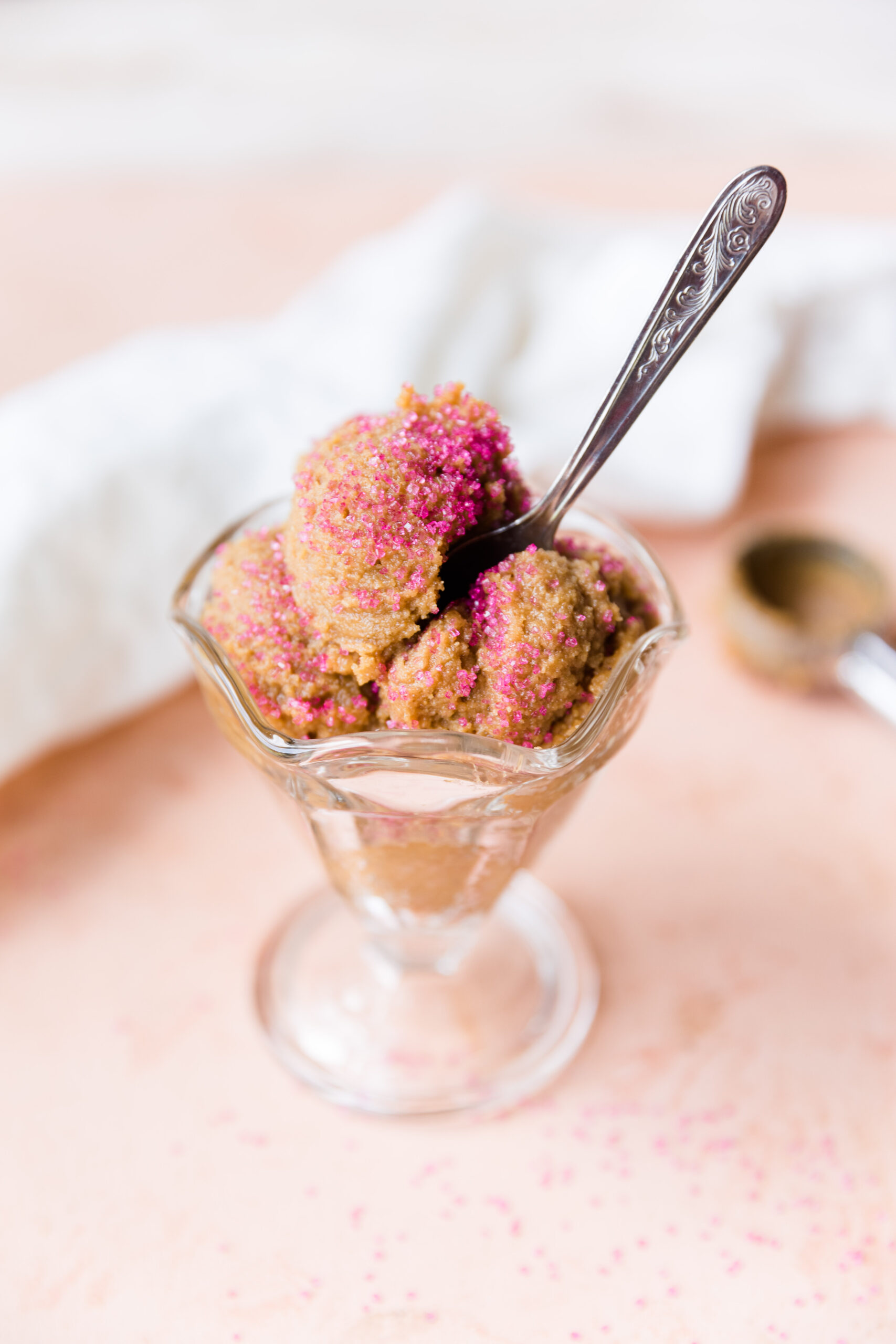Spoon sticking out of edible sugar cookie dough.