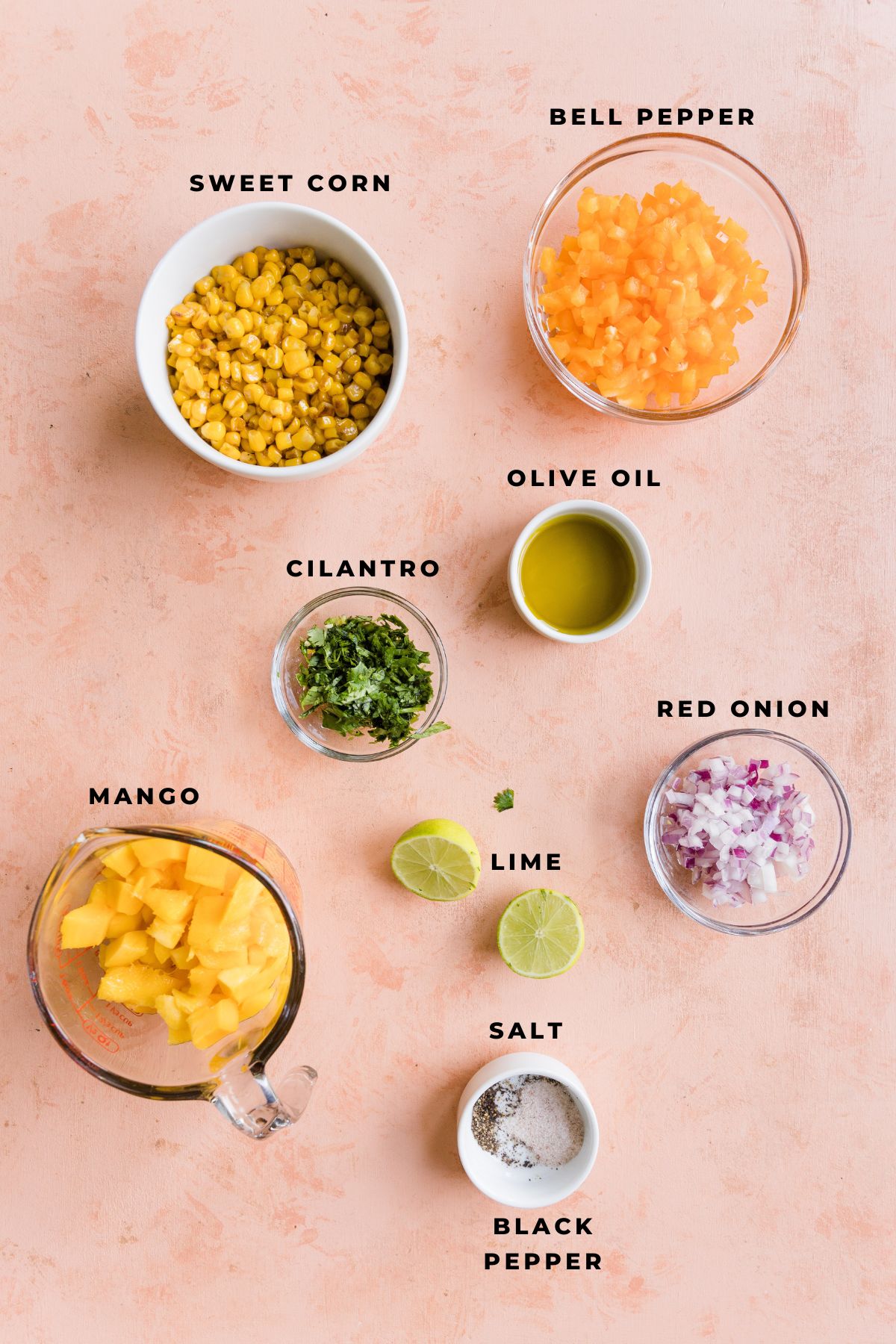 Ingredients for mango corn salsa measured out into small bowls.