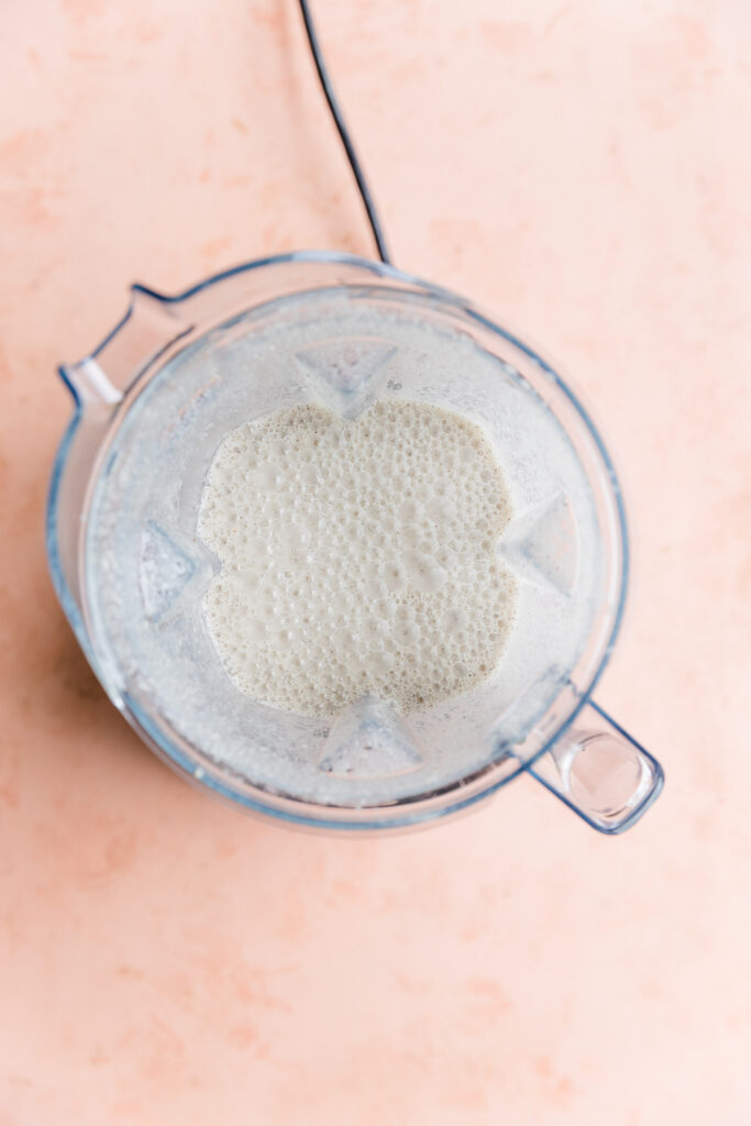 Creamy vanilla ice cream mixture in blender.