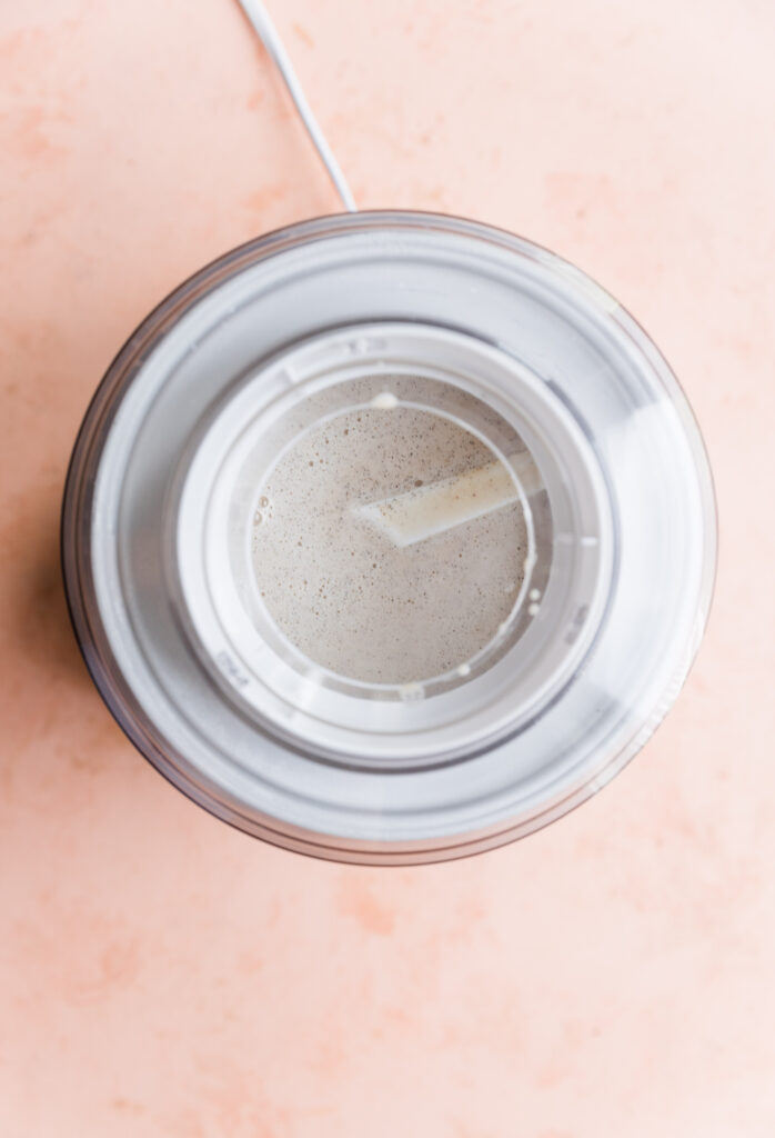 Dairy free vanilla ice cream mixture in ice cream maker.