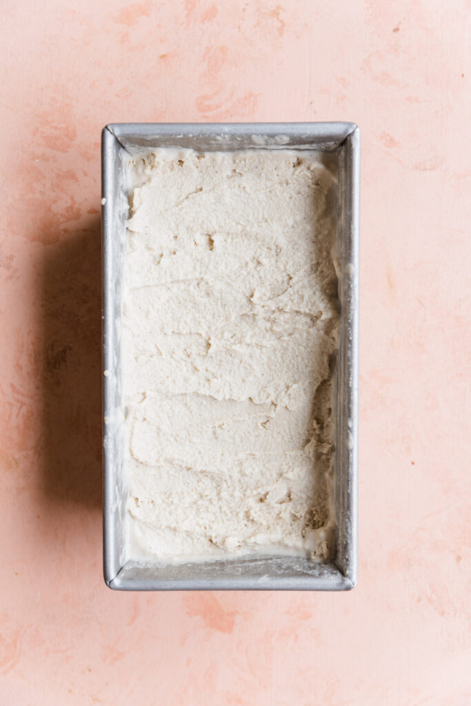 Creamy homemade vanilla ice cream in loaf pan.