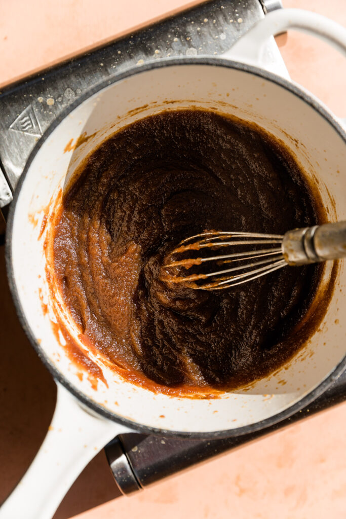 Thick date caramel apple dip in sauce pan.