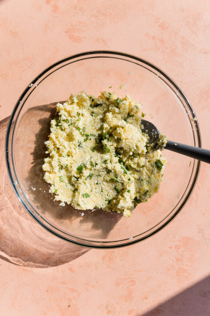 Cauliflower pizza crust dough in mixing bowl.