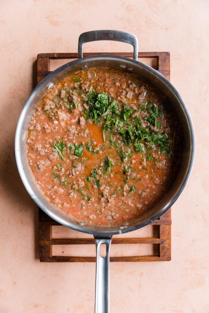 Meat sauce ingredients in a large pan.