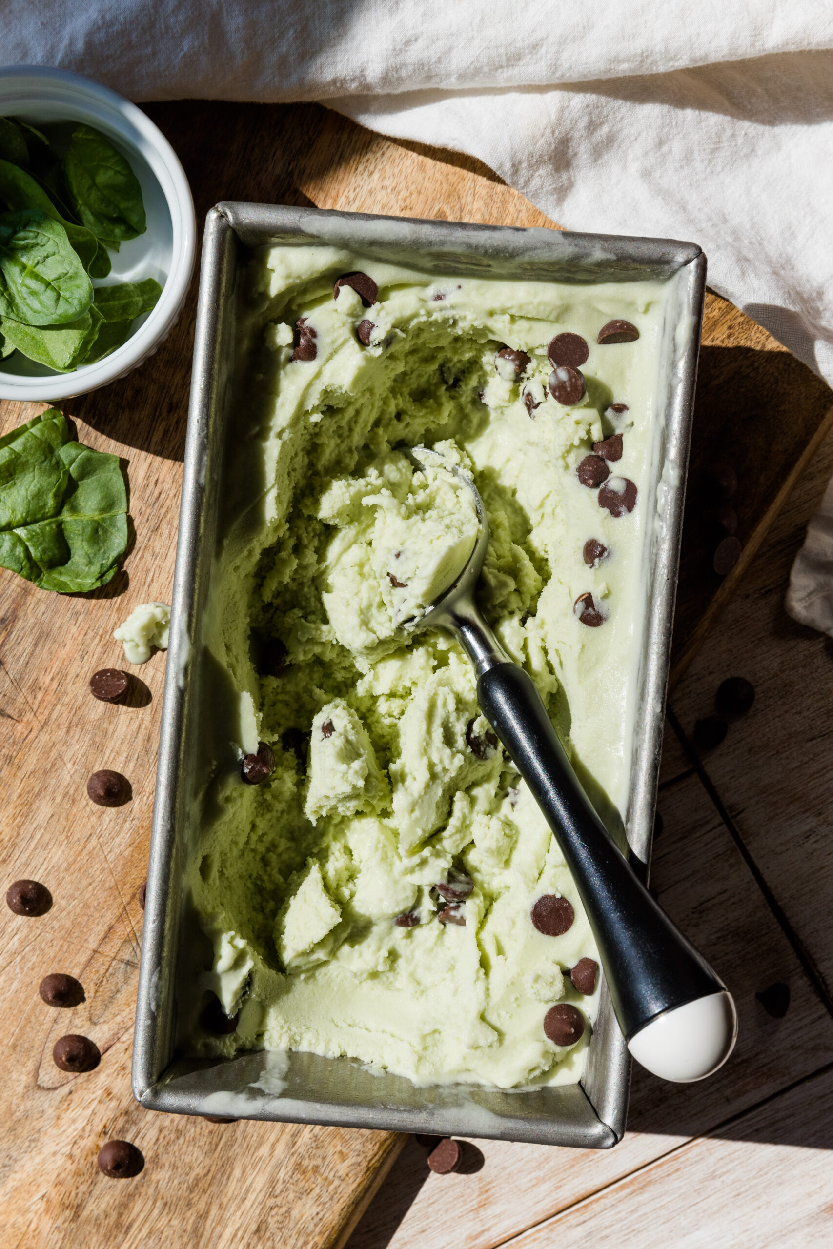 Ice cream scooper in mint chocolate chip ice cream.