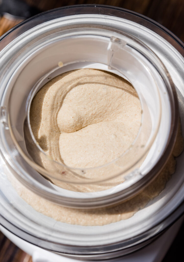 Creamy caramel ice cream churning in ice cream maker.