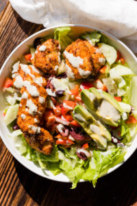 Crispy buffalo chicken salad drizzled with ranch dressing.