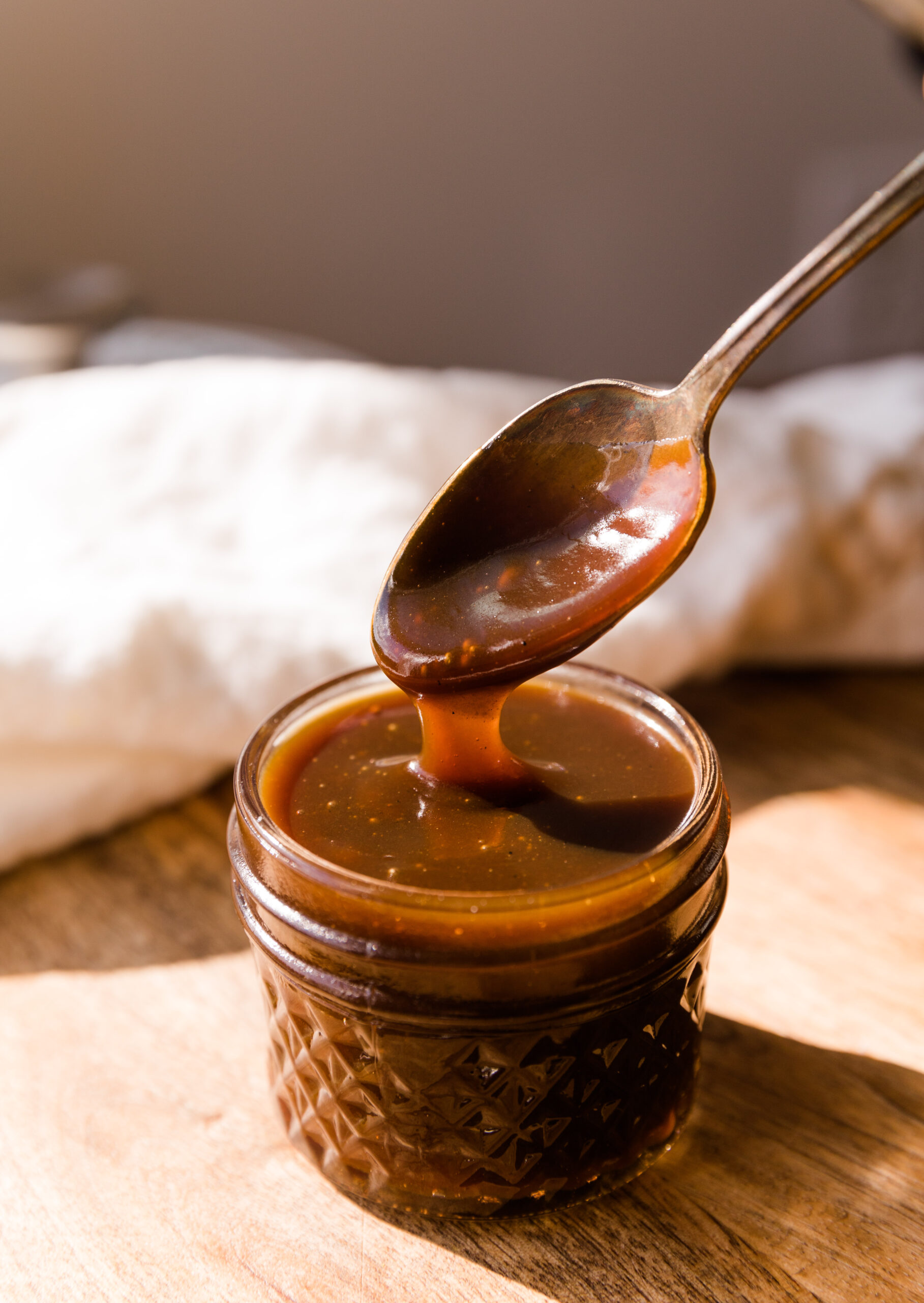 Spoon scooping out dairy free caramel.