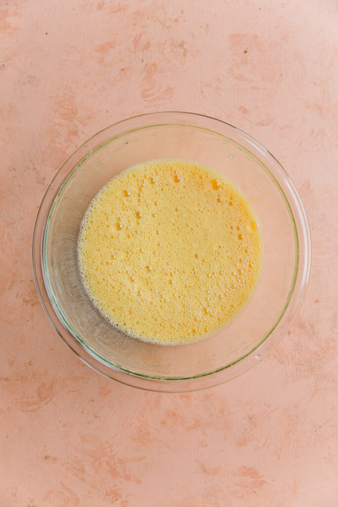 Egg mixture whipped together in mixing bowl.