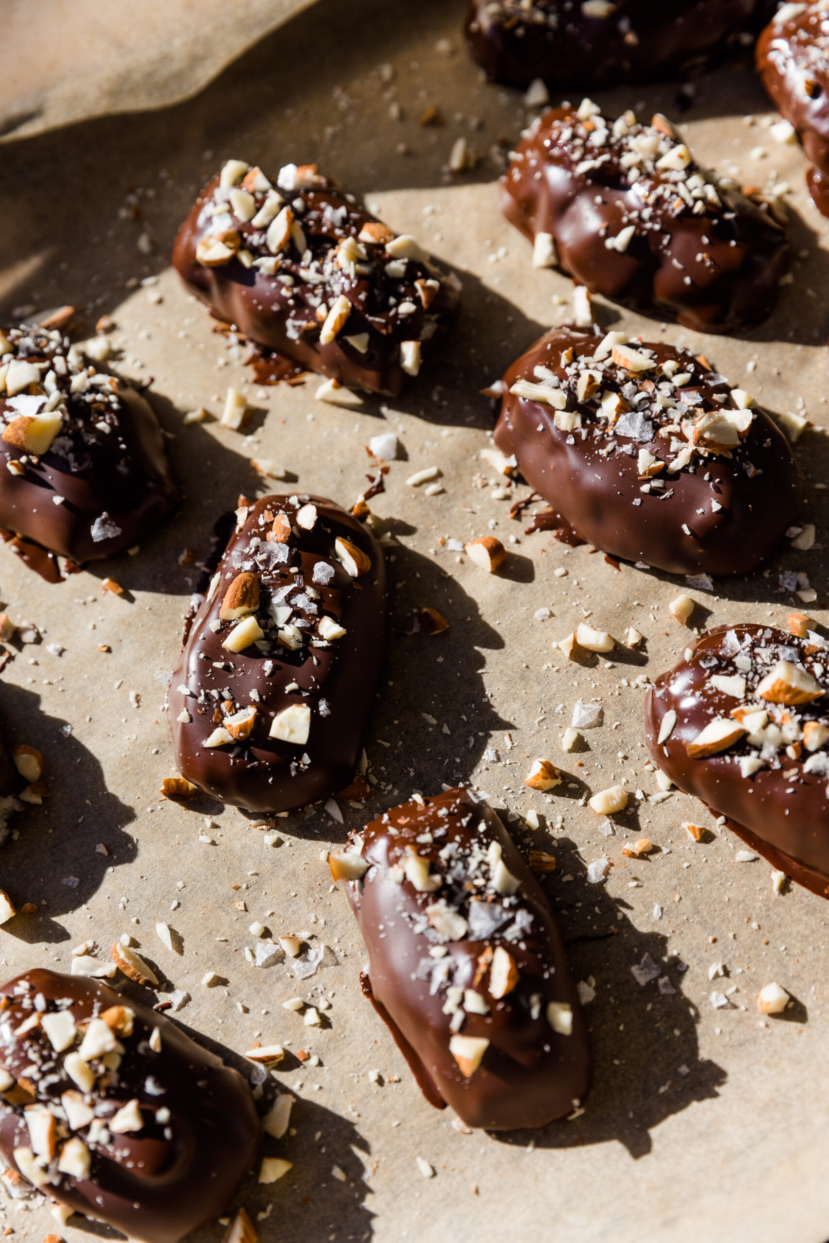 Close up of Almond joy candy bars on a parchment paper lined sheet.