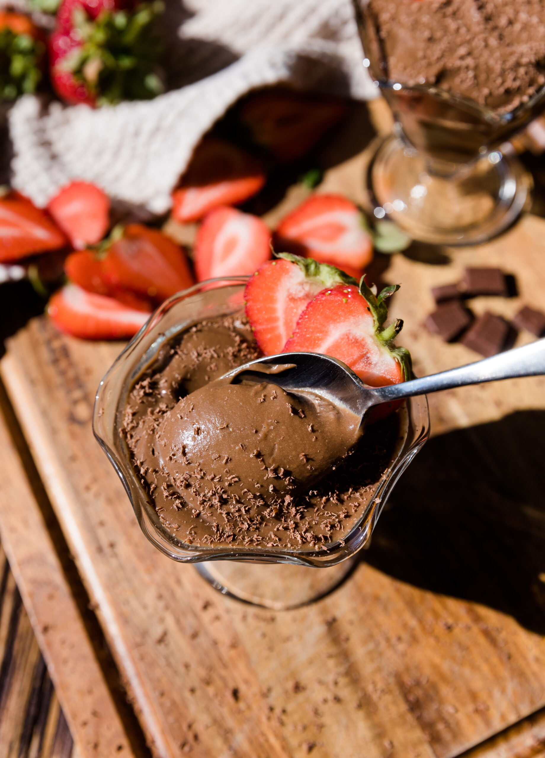 Spoon scooping out creamy avocado chocolate pudding.