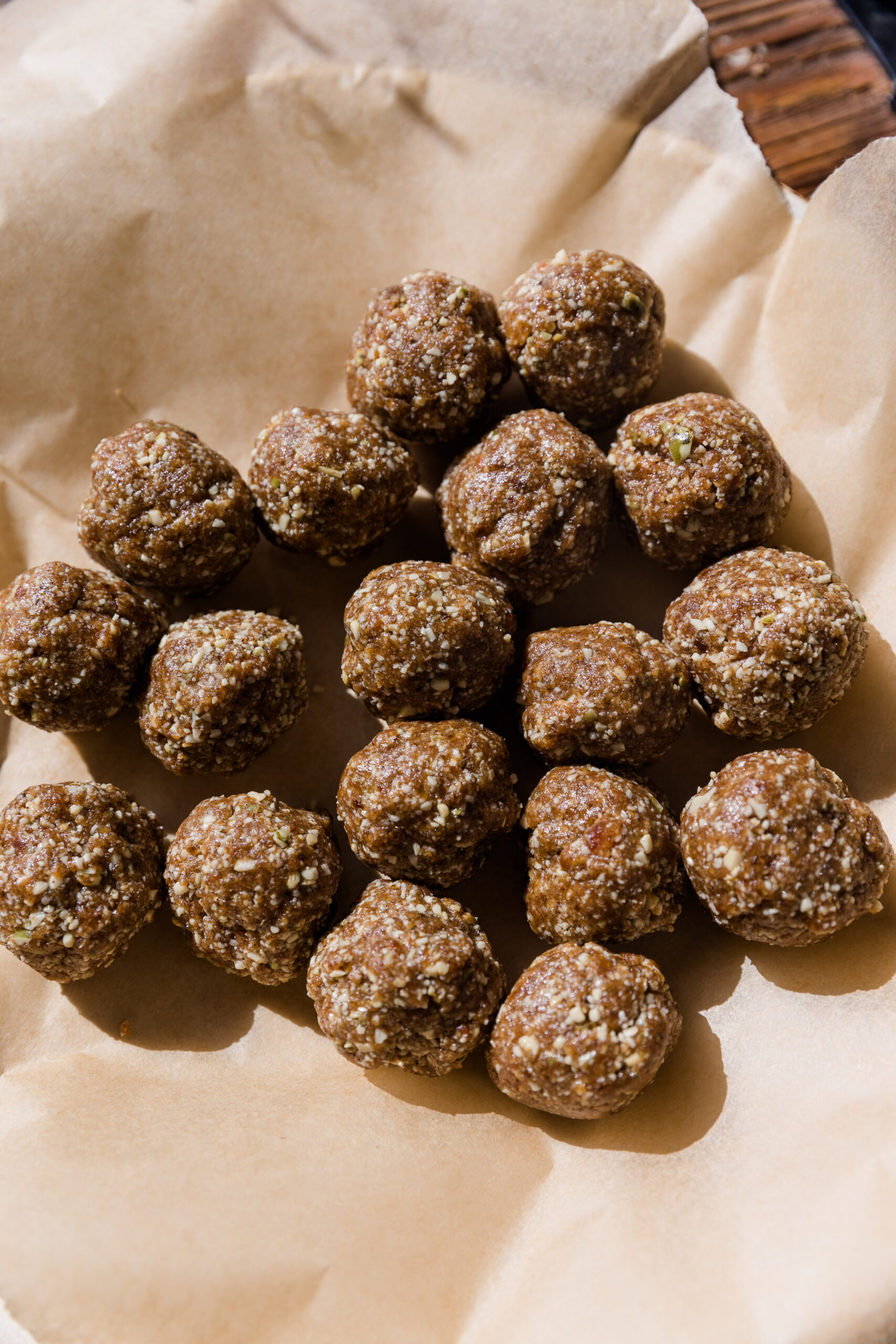 Cinnamon energy balls rolled onto parchment paper.
