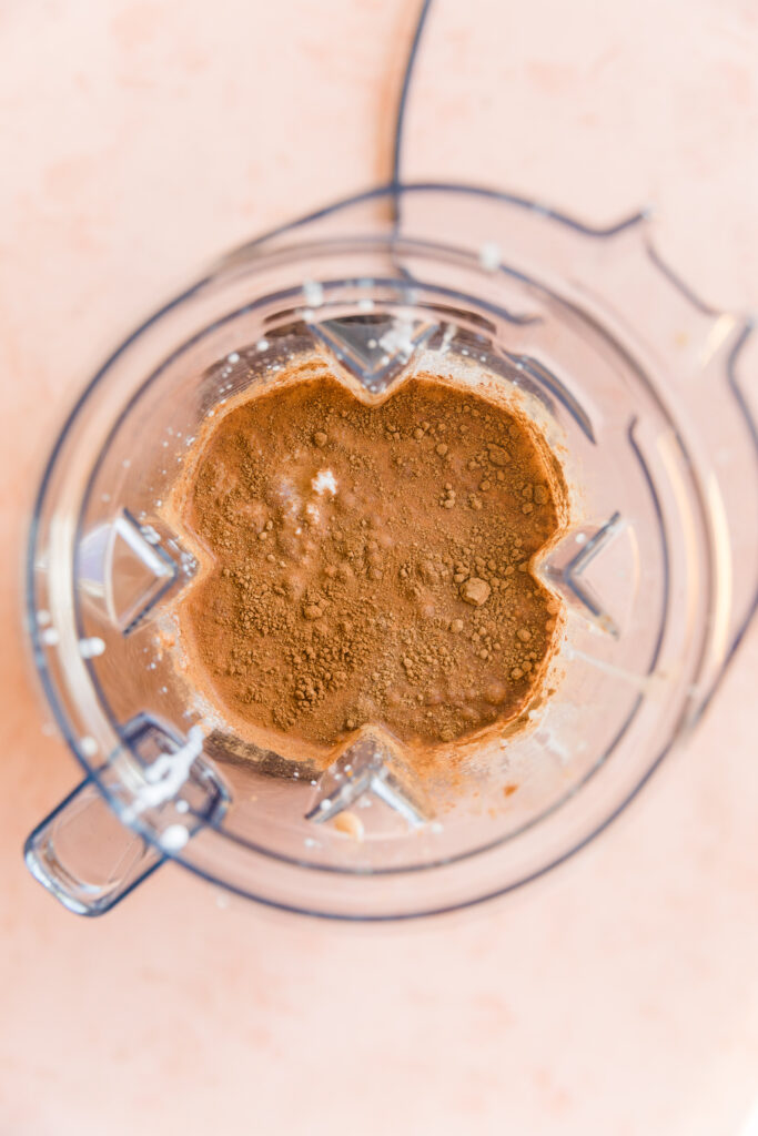 Creamy vegan pumpkin ice cream ingredients in blender.