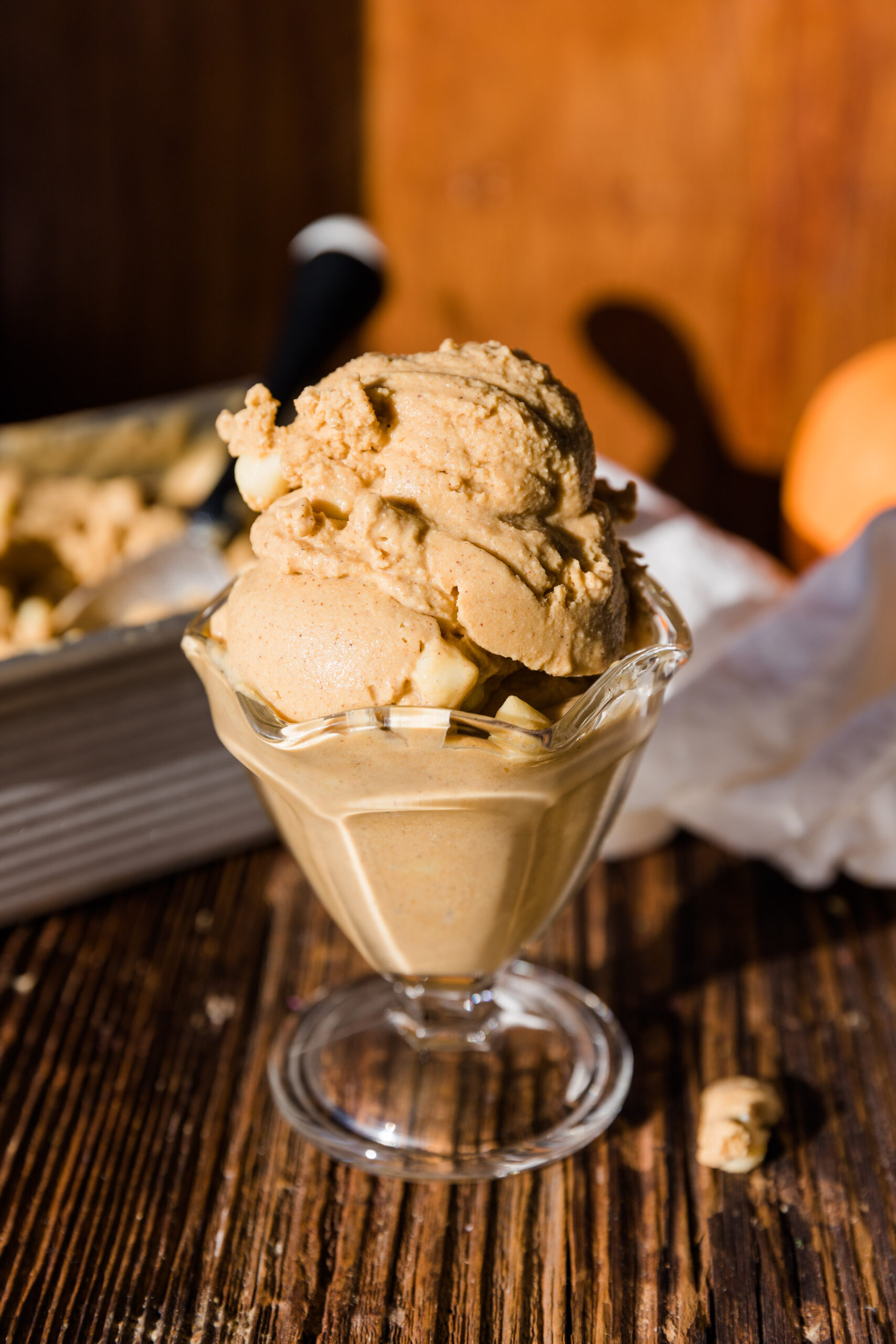 Close up picture of dairy free pumpkin ice cream in glass ice cream up.