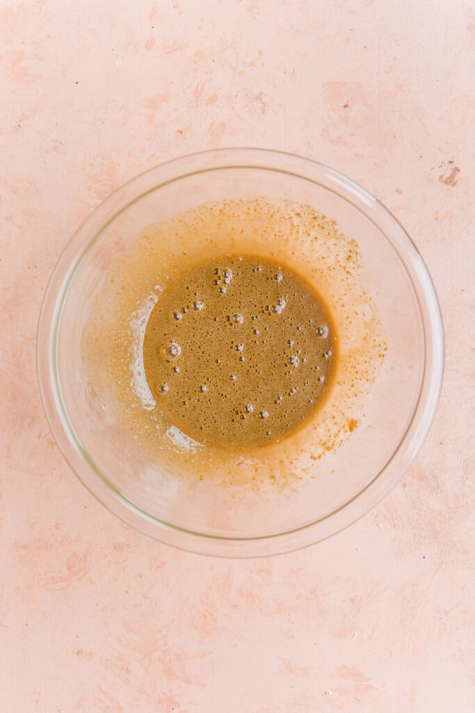 Wet ingredients in a glass mixing bowl.