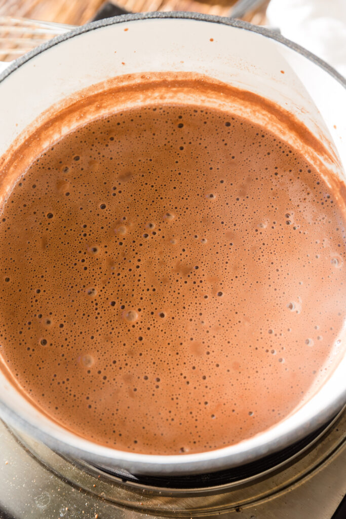 Smooth and creamy hot chocolate in saucepan.