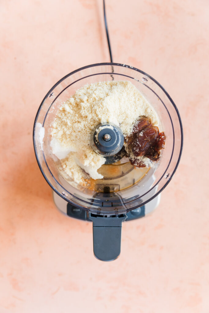 Almond flour cookie ingredients in food processor.