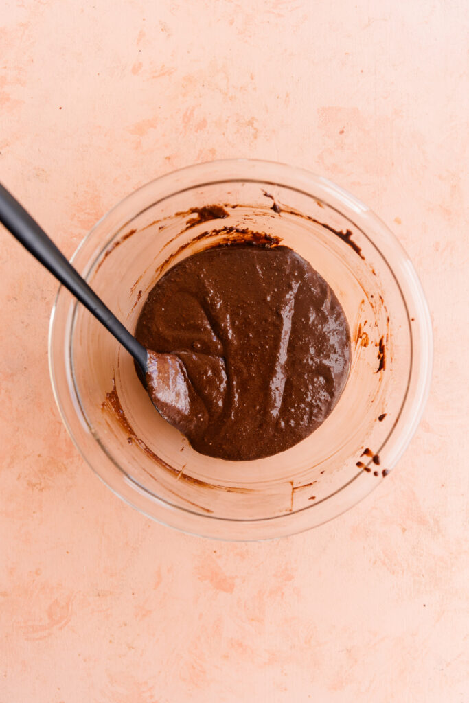 Brownie skillet batter in glass mixing bowl.